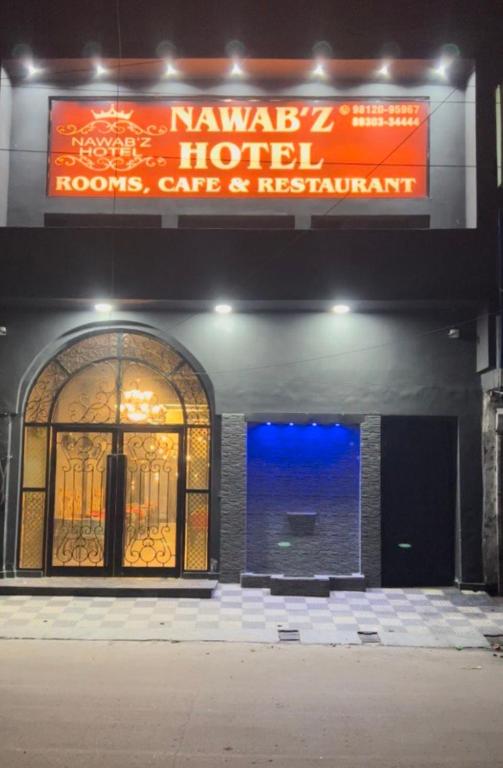 a building with a sign for a hotel at Nawabz Hotel in Karnal