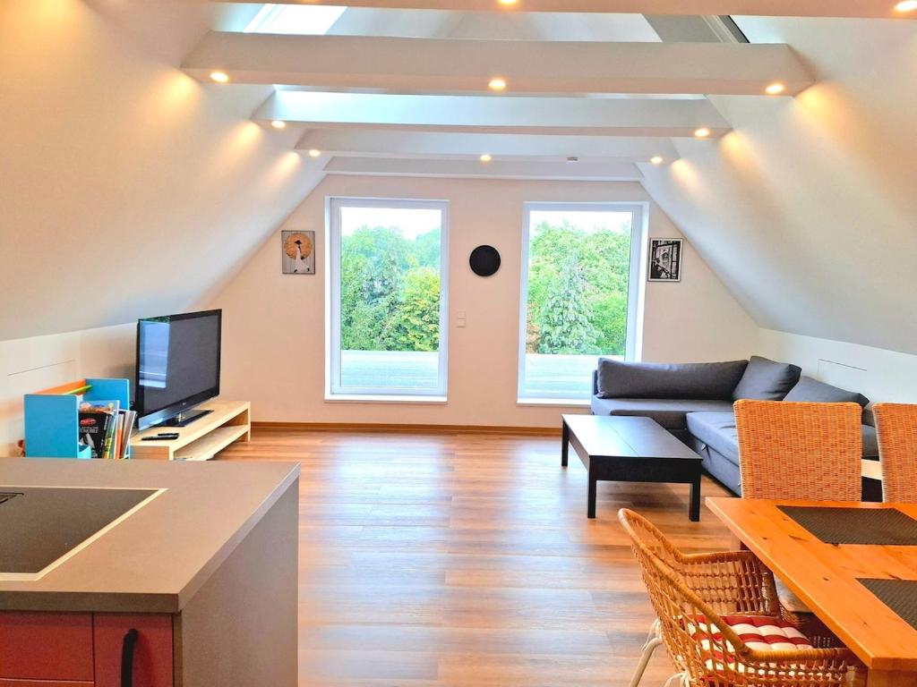 a living room with a couch and a table at Helle Dachgeschosswohnung, neu renoviert & ruhig in Wolfenbüttel