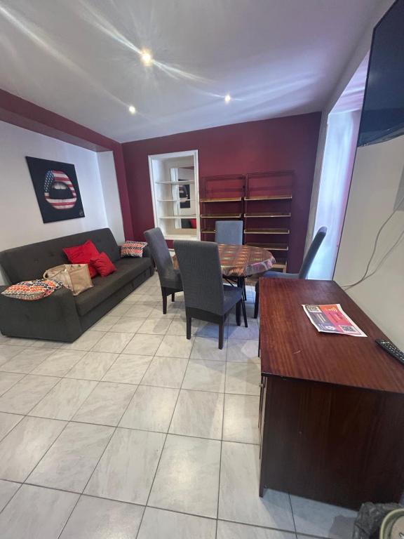 a living room with a couch and a table at Location saisonnière in Sospel