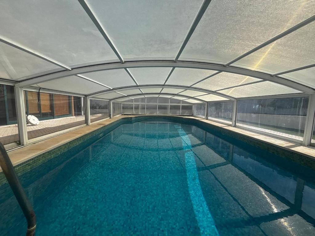 a large swimming pool with a large pool at Casa do Meco - Private Pool in Sesimbra