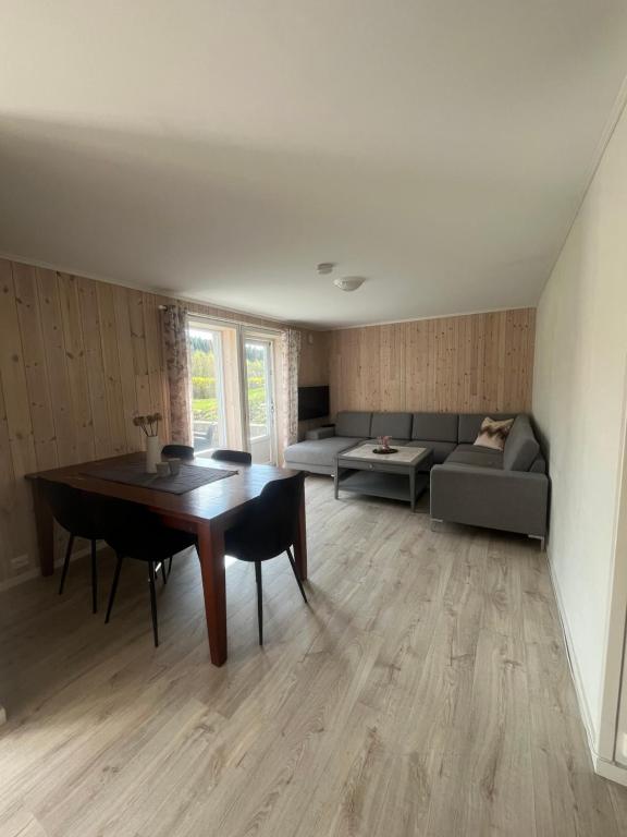 a living room with a table and a couch at Hammervatnet Ro in Levanger