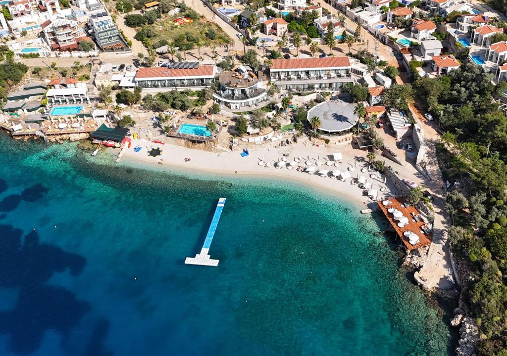 an aerial view of a beach with a boat in the water at Kalkan Beach Park Hotel in Kaş