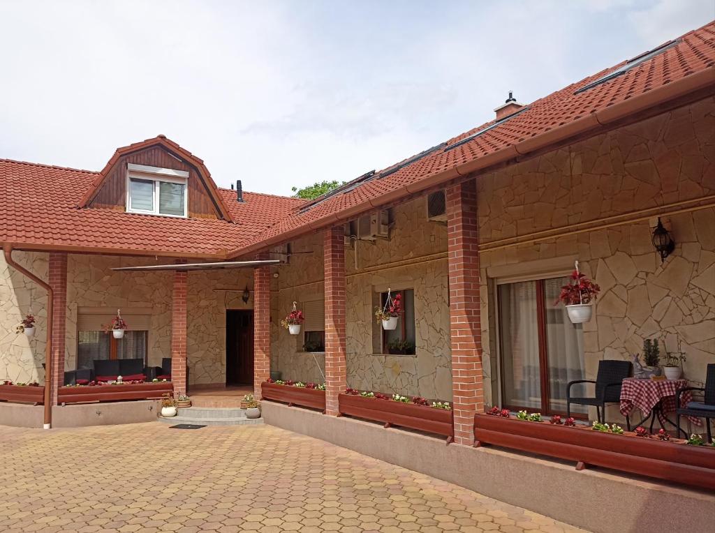 a brick house with a patio and a porch at Euro Accommodation in Debrecen