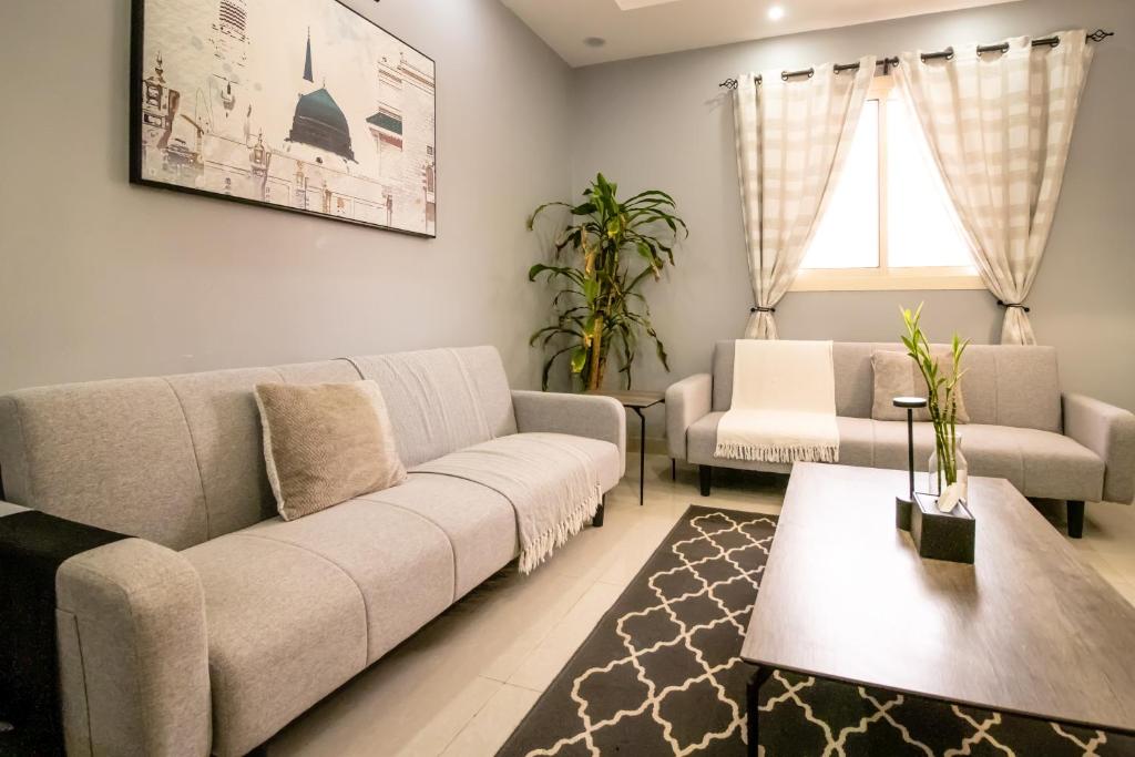 a living room with a couch and a table at HOMEY iNN in Medina