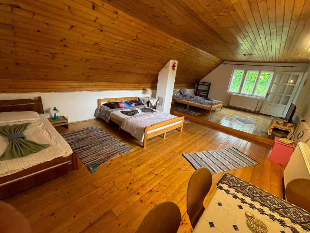 a large bedroom with a bed and a wooden ceiling at Casa Dalia 2 in Sighişoara