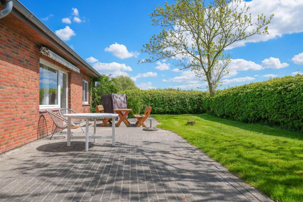 a patio with a table and two chairs in a yard at Mor Mor Hus in Böhl