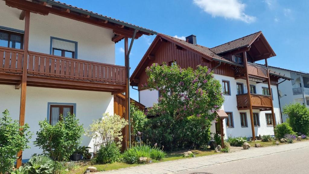 a row of houses with wooden balconies on a street at Appartementhaus Elisabeth Winklhofer in Bad Füssing