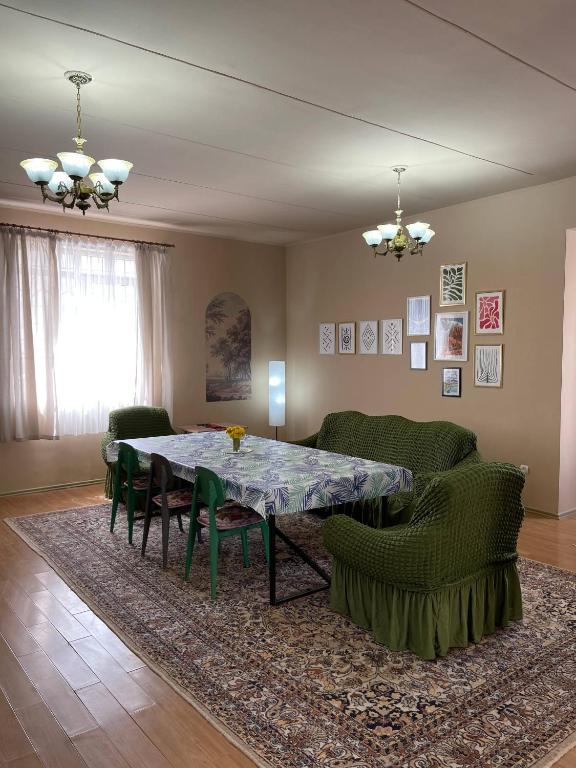 a living room with a table and chairs at Wings Ethno in Cholpon-Ata