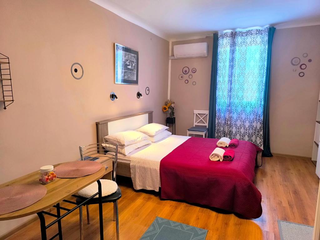 a bedroom with a bed and a table and a table at Guest House Barocco in Rovinj