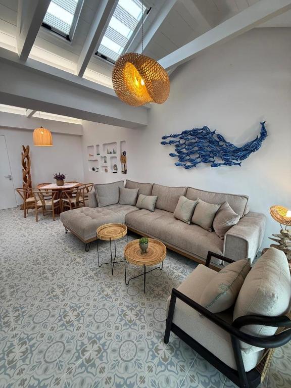 a living room with a couch and a table at Villa Metaxa Barbati Beach Corfu in Barbati