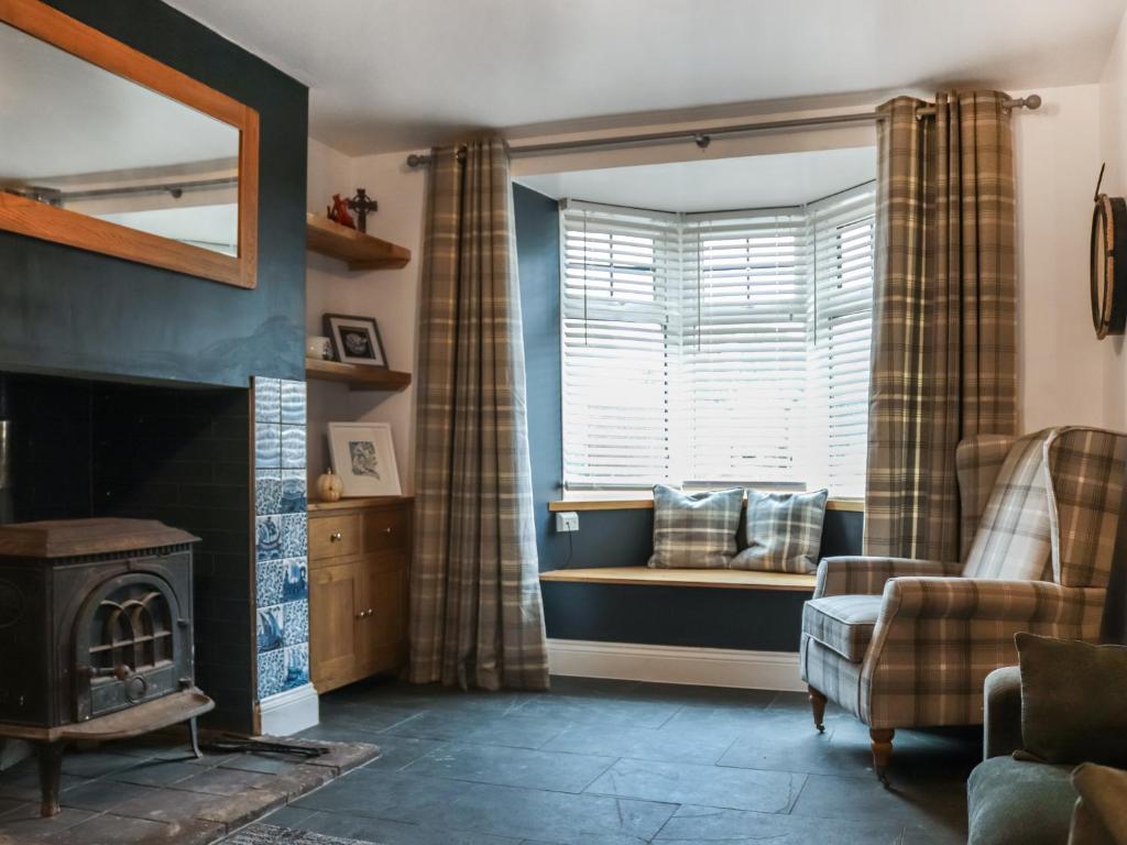 a living room with a couch and a window at The White Anchor in Newborough