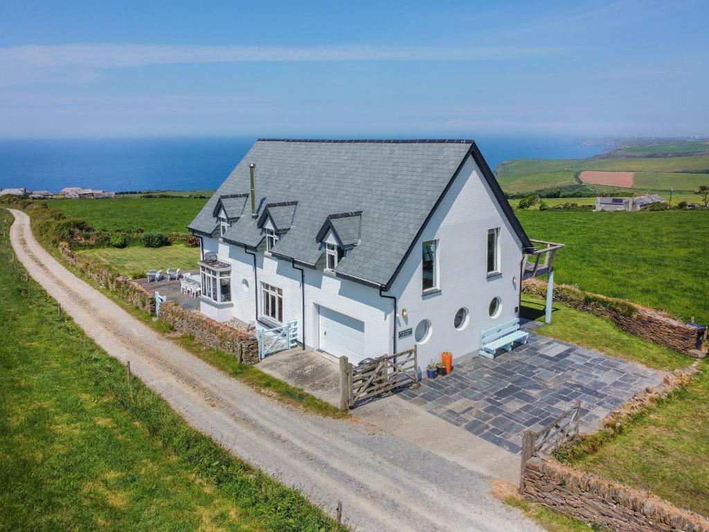 an overhead view of a white house in a field at Lower Hendra Cottage in Port Isaac