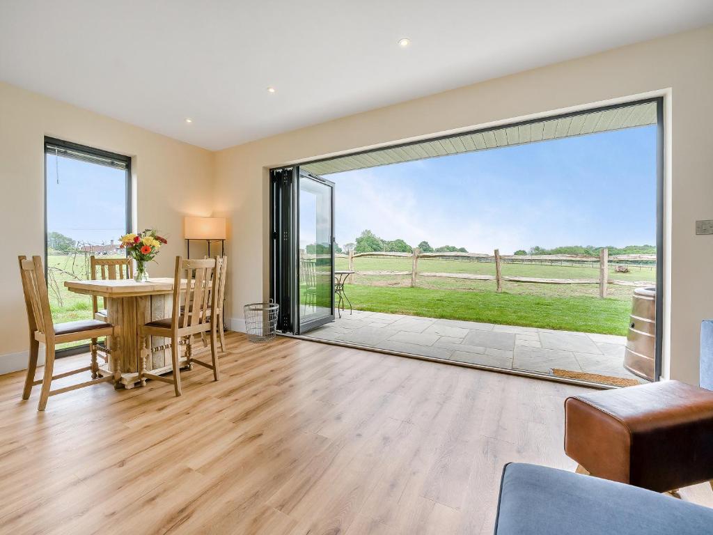 a dining room with a table and a large sliding glass door at Hillview in Horsham