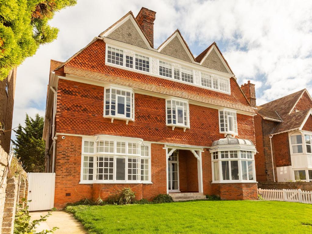 a large red brick house with white windows at West Bay House in Westgate-on-Sea