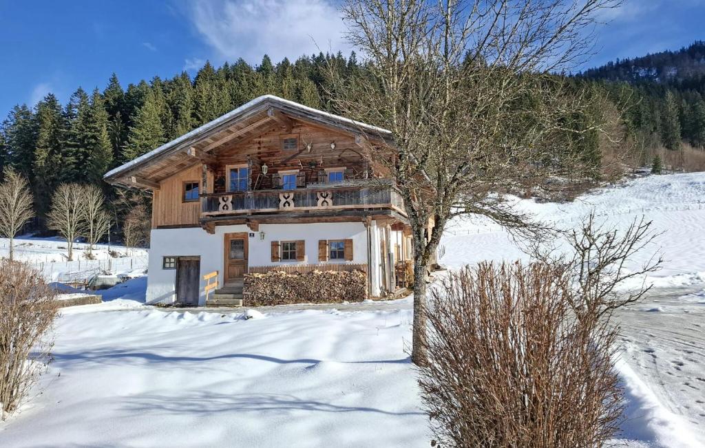 a log home in the snow with snow covered ground at Charmantes Ferienhaus in Schwendt