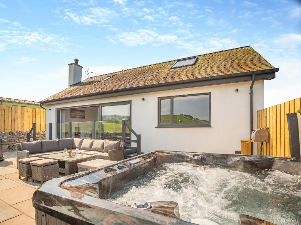 a hot tub in the backyard of a house at Goppa in Llanfair