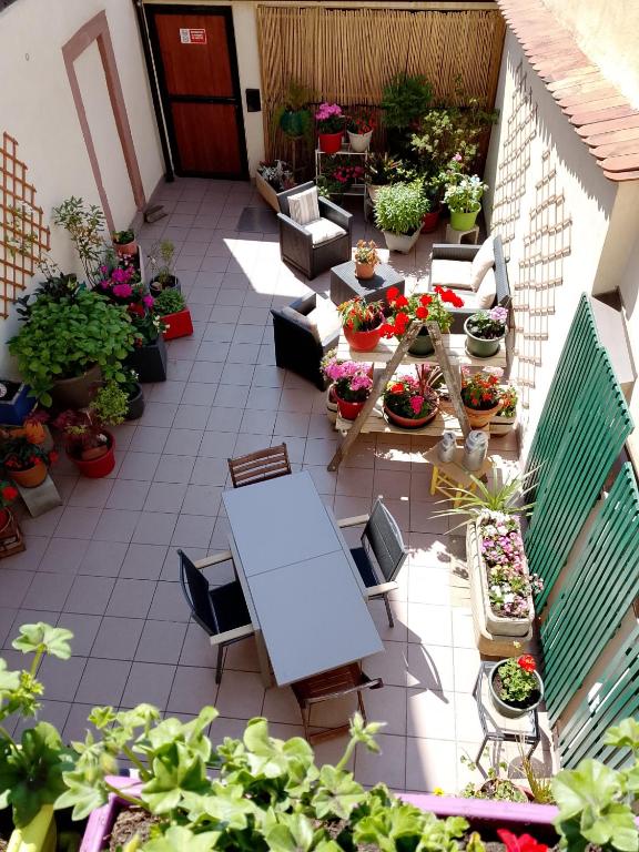 a patio with a table and a lot of potted plants at Le Balcon in Sélestat
