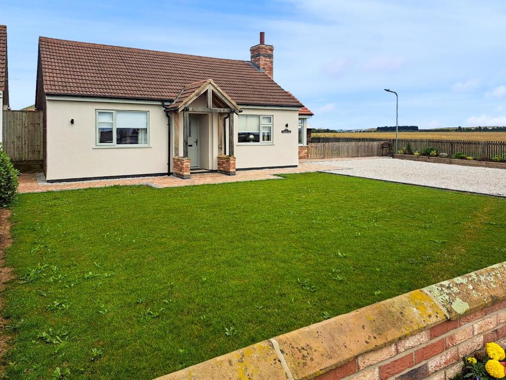 a house with a lawn in front of it at Normandy in Wyberton