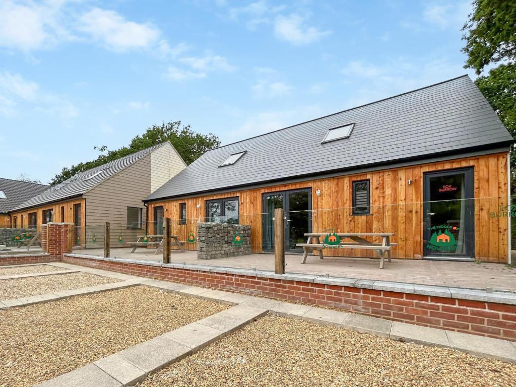 a wooden building with a bench in front of it at No 4 Squirrels Nest-Uk44305 in Lenwade