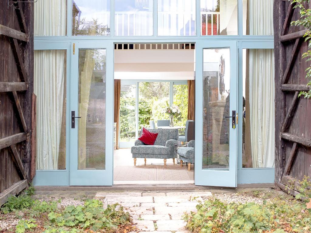 an open door to a patio with a couch and chairs at The Hall - Uk32690 in Horton
