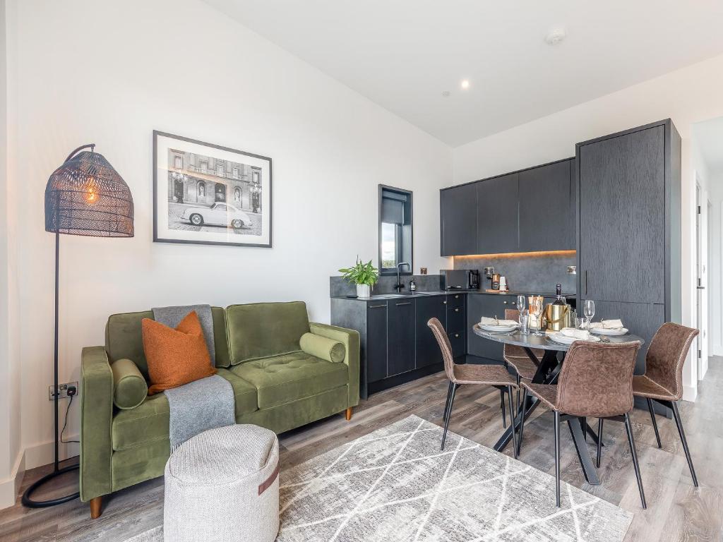 a living room with a green couch and a table at Cadnant Lodge 2 - Uk42795 in Llangefni