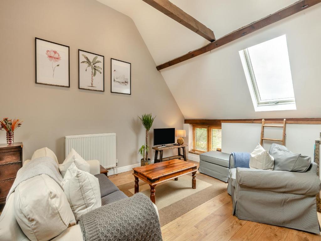 a living room with a couch and a table at The Cartlodge - Ukc1039 in Hickling