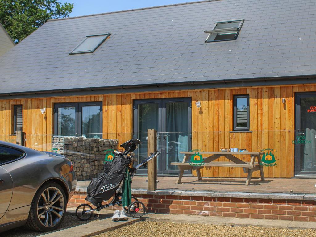 a person on a bike in front of a house at No 1 Fox Burrow-Uk44306 in Lenwade