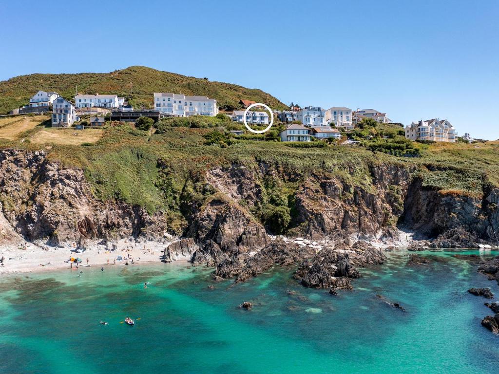 a group of people swimming in the water at a beach at Seaglass in Mortehoe