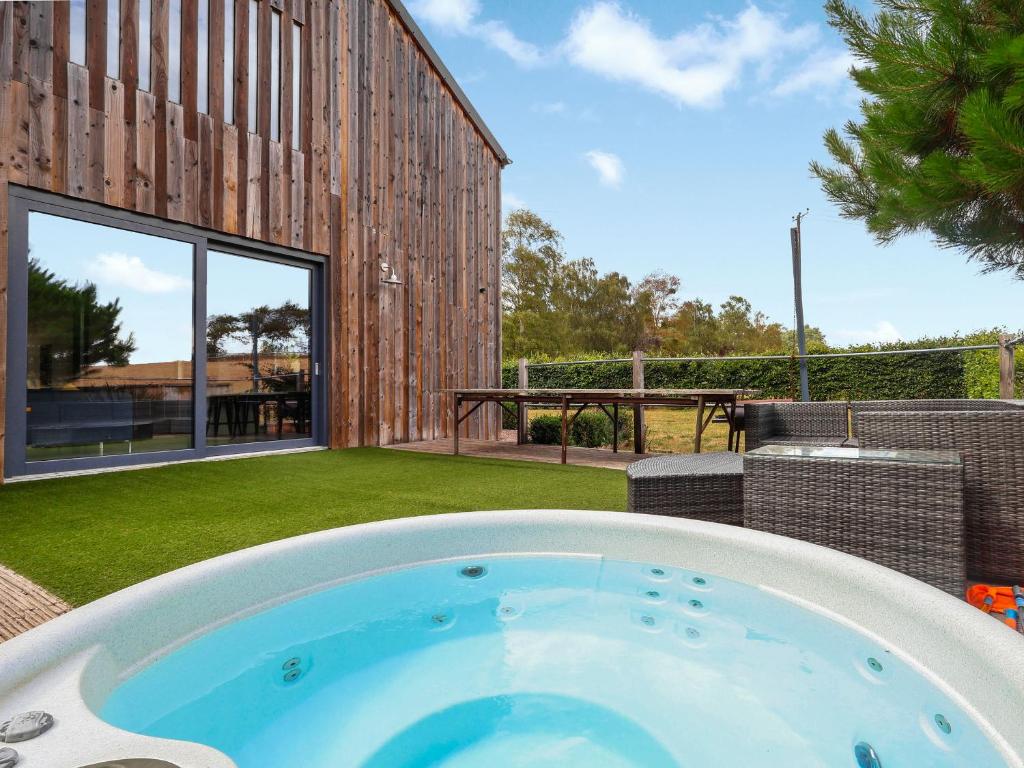 a hot tub in the backyard of a house at The Grain Dryer in Gloucester