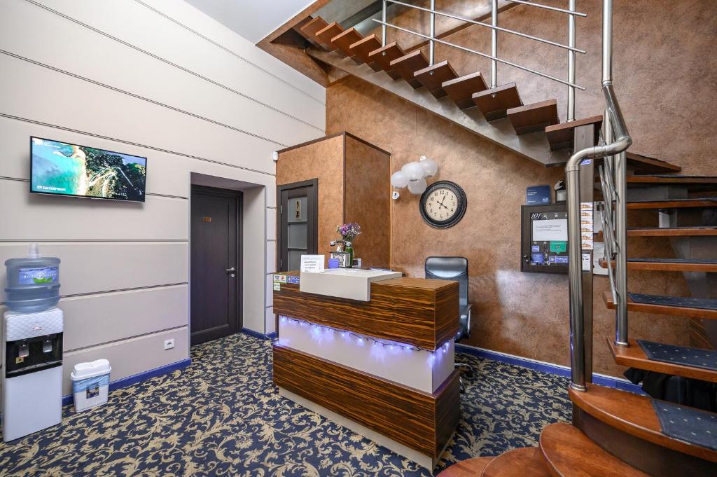 a waiting room with a cash register and stairs at G40 Boutique Hotel in Odesa
