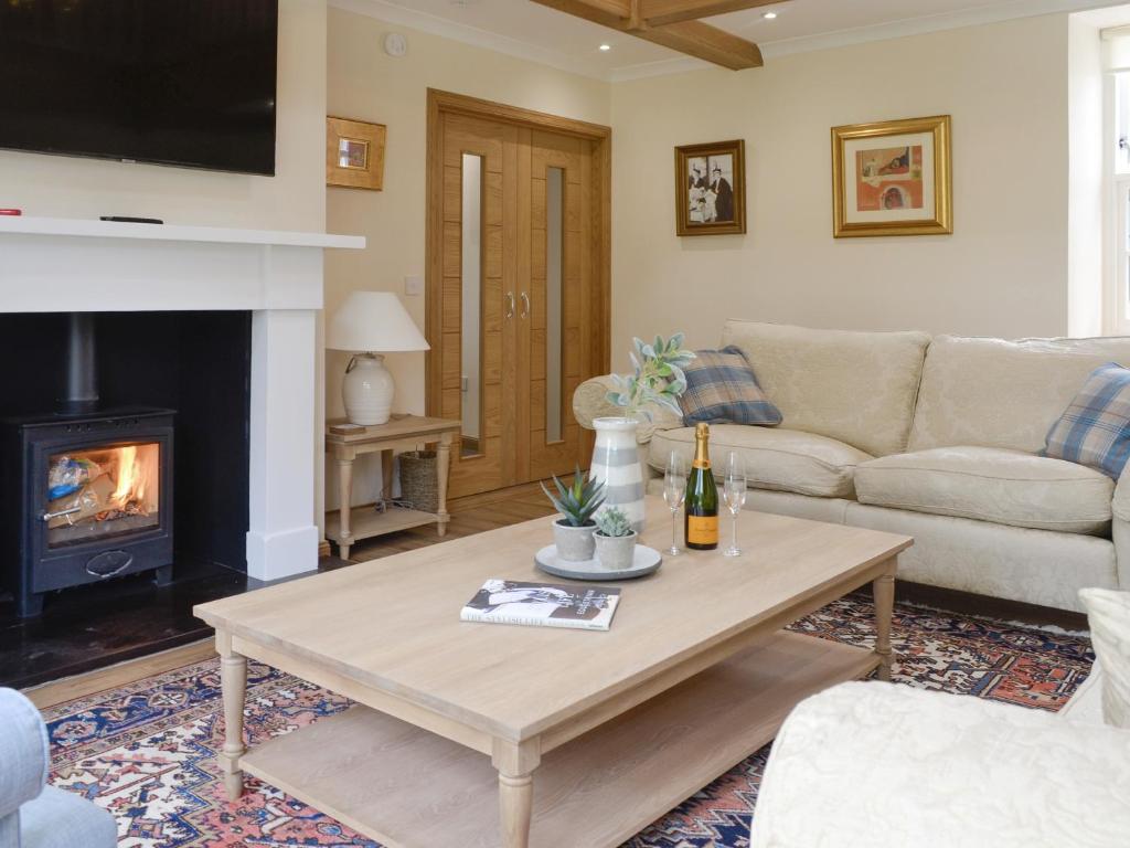 a living room with a coffee table and a fireplace at The Stables - Uk11108 in Montrose