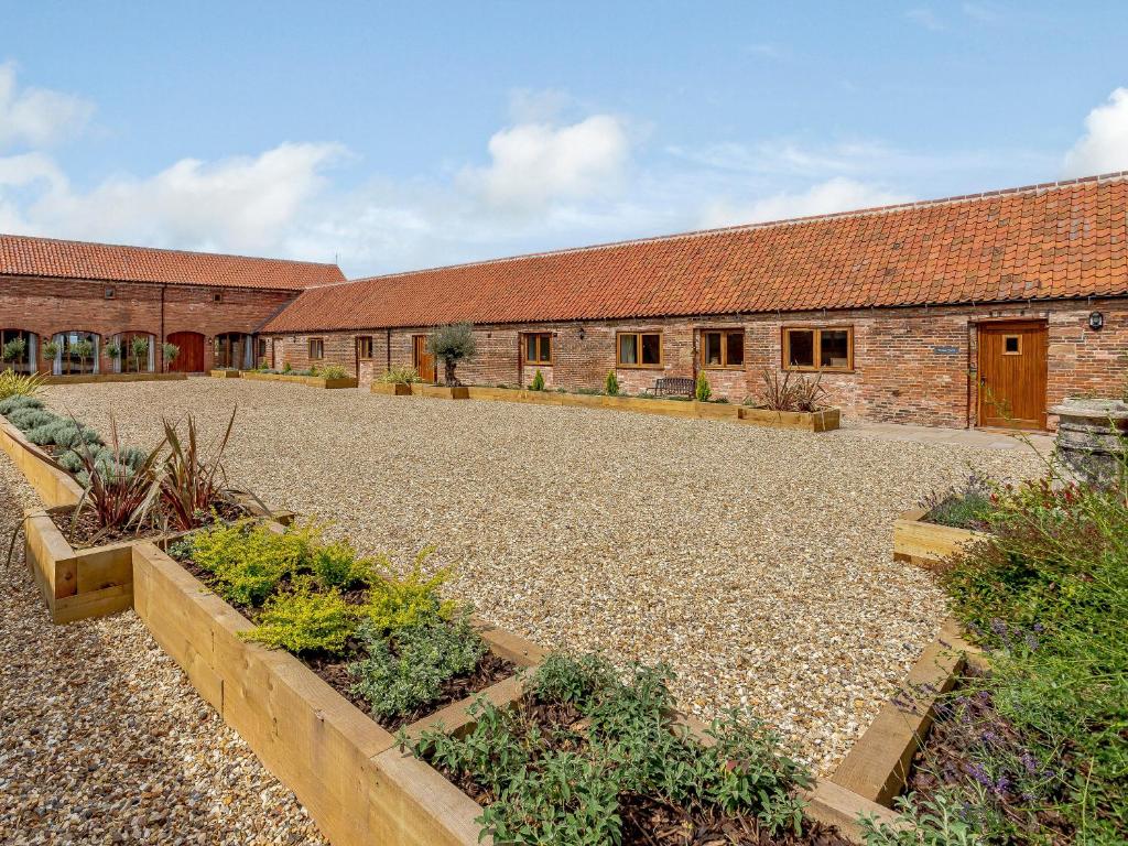 a courtyard in front of a building with plants at The Wheat Store - Uk32649 in Elston