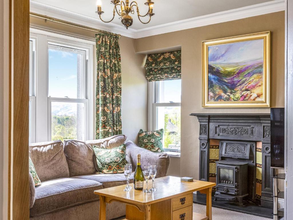 a living room with a couch and a fireplace at Mount Pleasant in Threlkeld