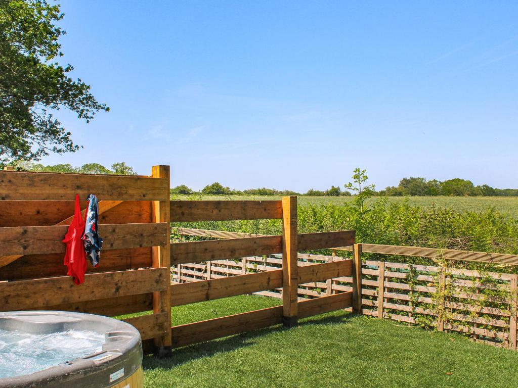a wooden fence with a field in the background at No 2 Badger Sett-Uk44307 in Lenwade