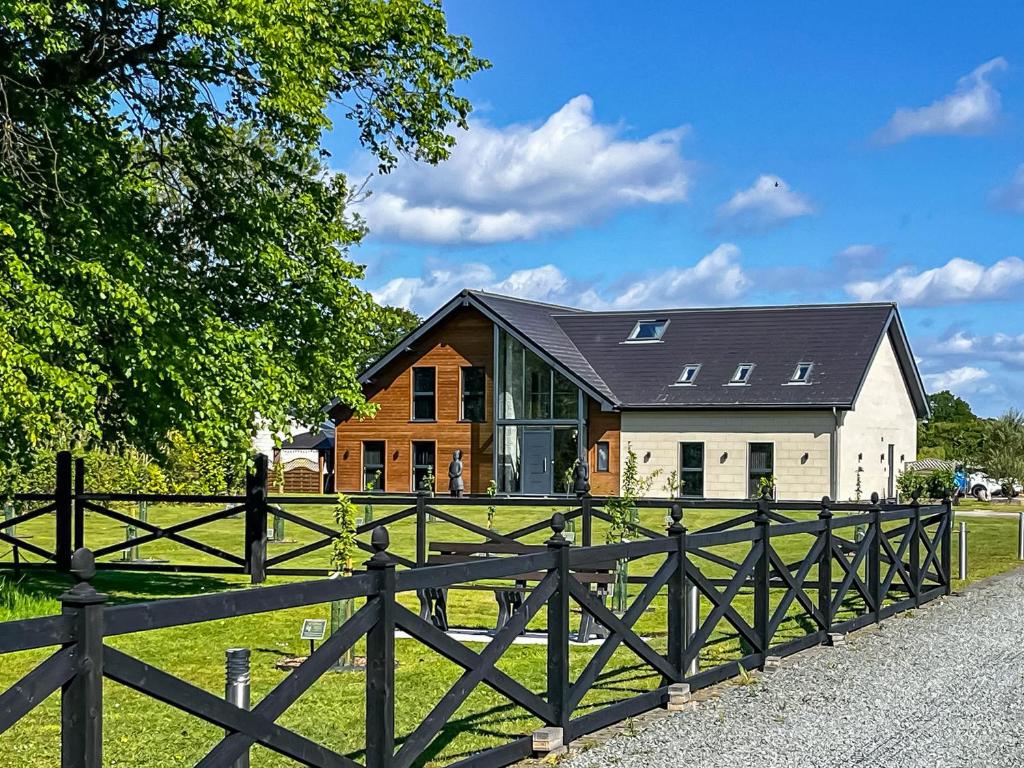 a large house with a fence in front of it at The Paddocks Retreat in North Thoresby