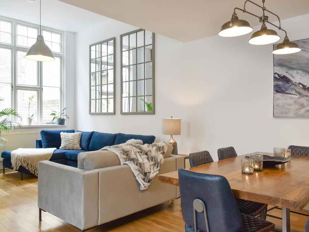 a living room with a couch and a table at Old Parish Hall in Ramsgate