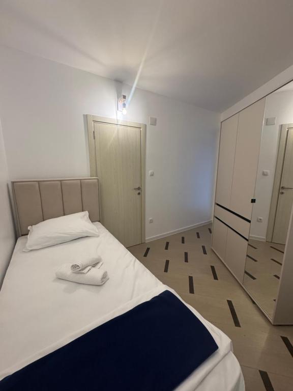 a bedroom with a bed with a towel on it at Green Oasis Budva in Prijevor