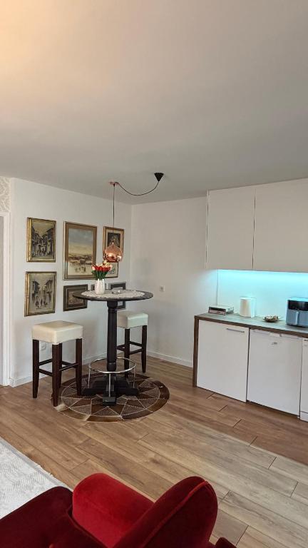 a living room with a table and a kitchen at Baklava in Sarajevo