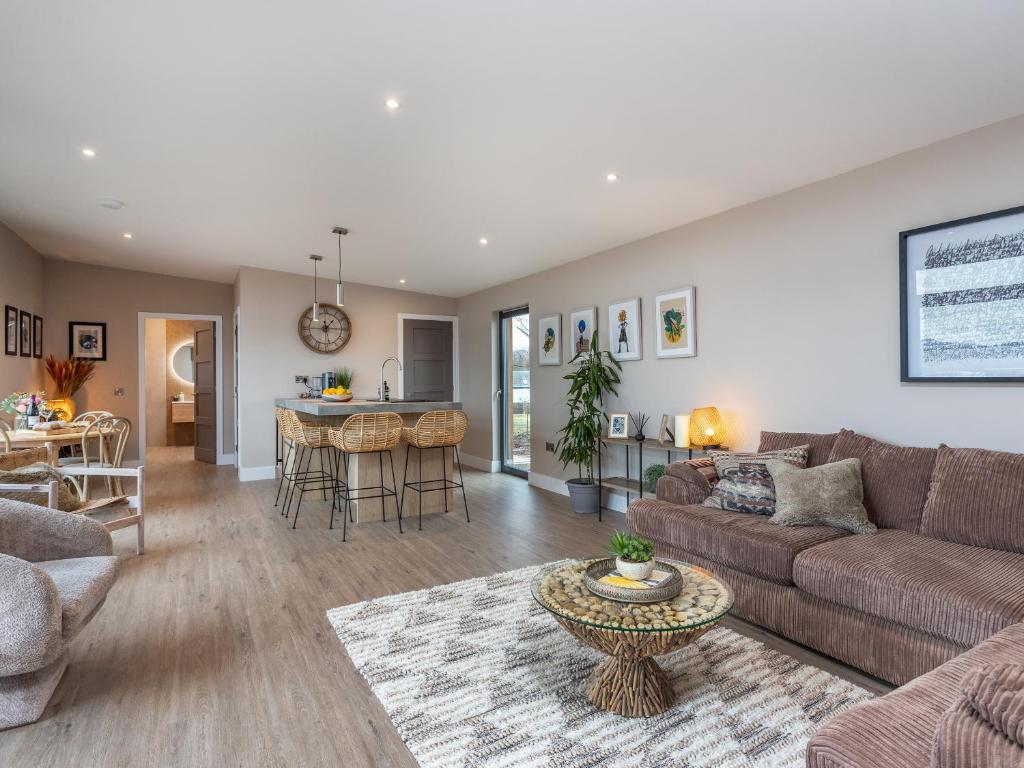 a living room with a couch and a table at The Granary - Uk48622 in Buchlyvie