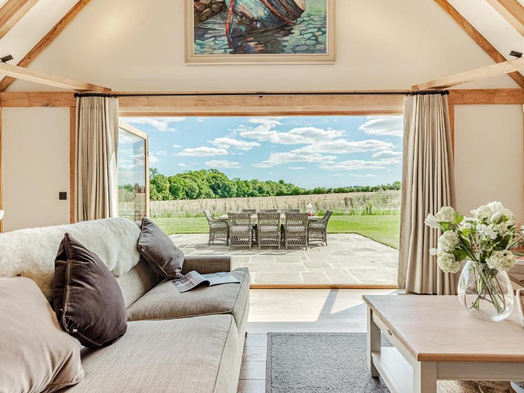 a living room with a couch and a table at Lovington Barn in Ovington
