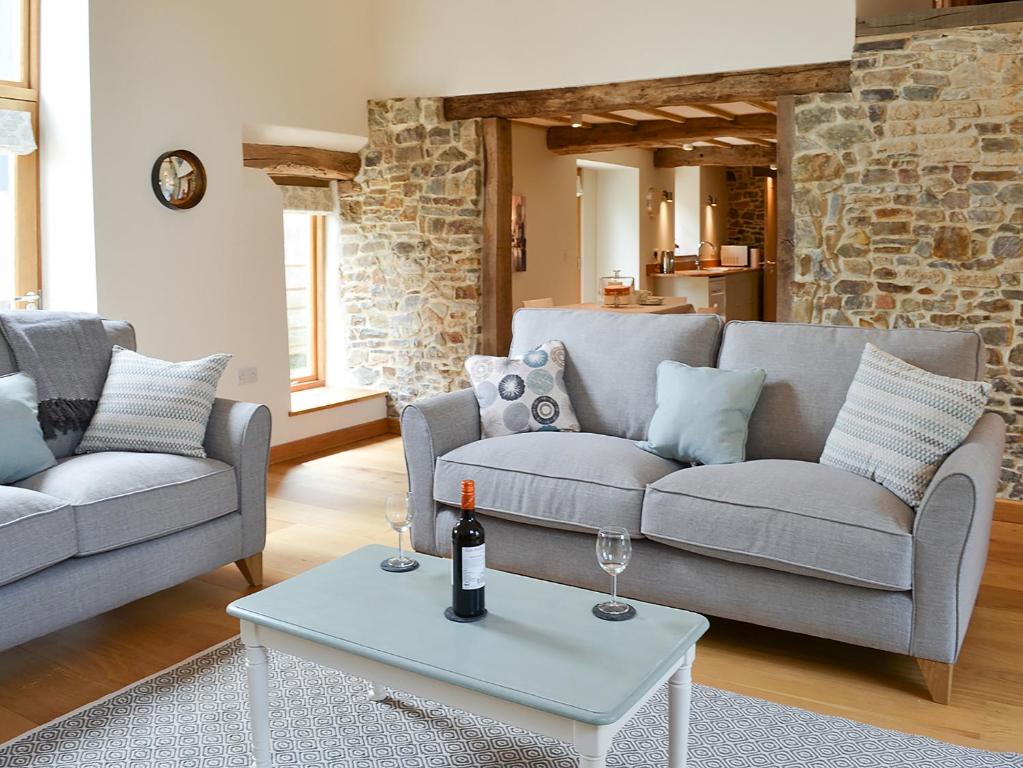 a living room with two couches and a table at The Oak Stall - Uk11023 in East Worlington