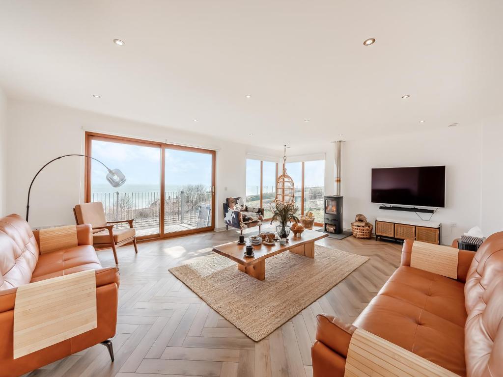 a living room with two couches and a tv at The Beaches in Berwick-Upon-Tweed