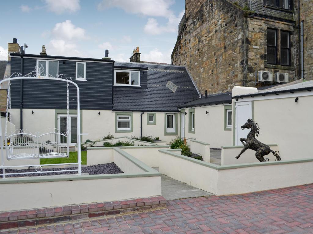a statue of a horse on the side of a building at Apple Tree House in Dalry