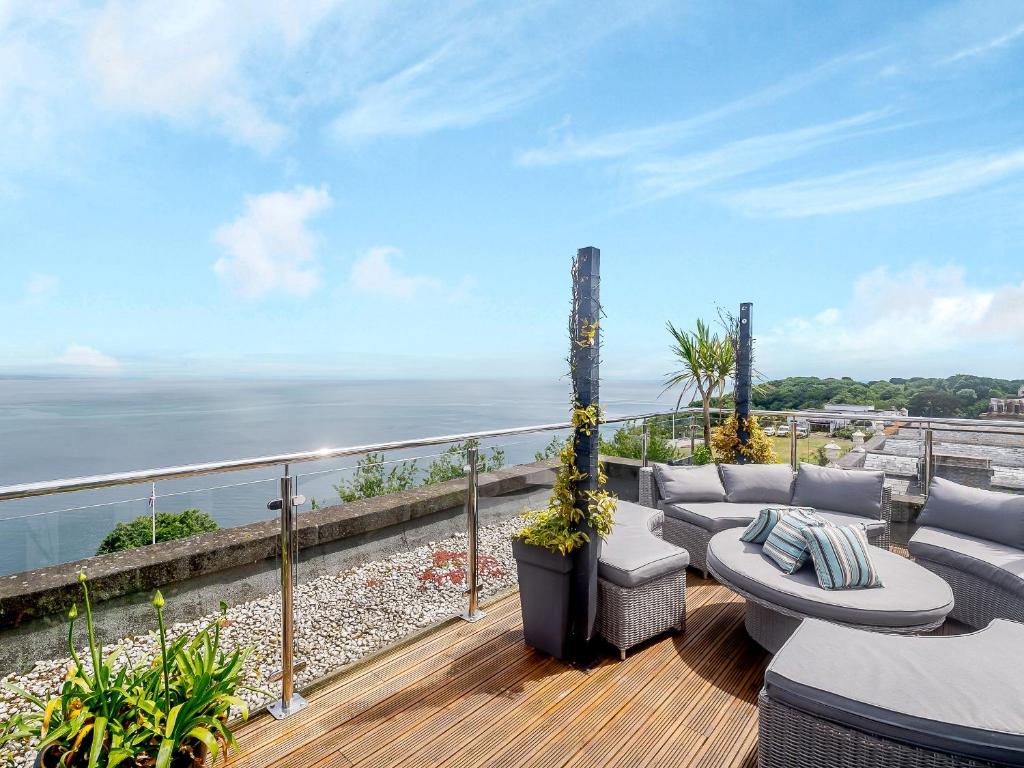 a balcony with couches and a view of the ocean at Babbacombe House in Torquay