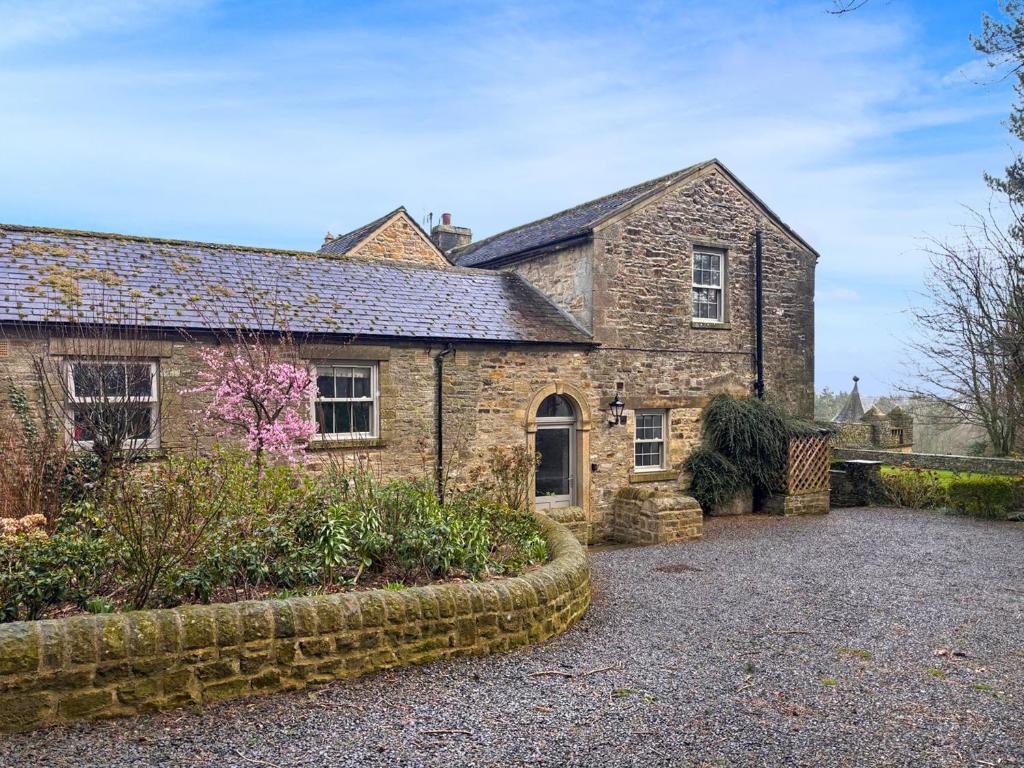 an old stone house with a garden in front of it at West House - Uk51668 in Leyburn