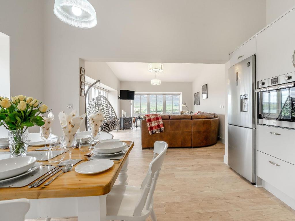 a kitchen and dining room with a table and chairs at The Stables in Stanhope