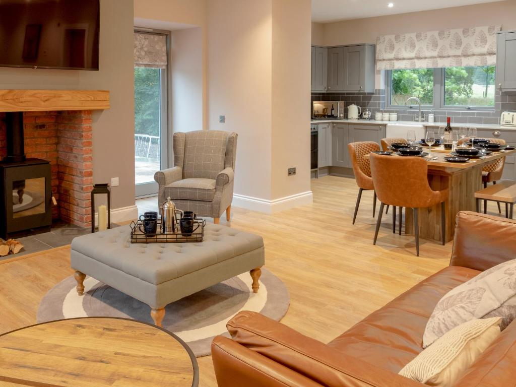 a living room with a couch and a table at Slatehouse Cottage - Uk7562 in Carronbridge