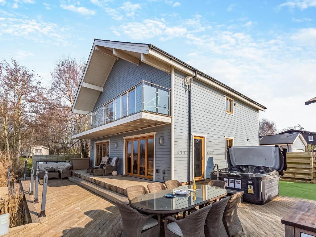 a house with a patio and a grill at Malibu Lakehouse in Pentney