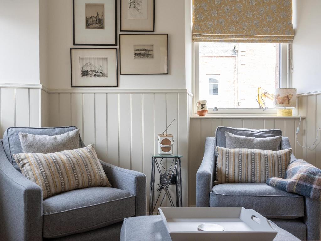 a living room with two chairs and a table at Croft House - Uk7555 in Inverness