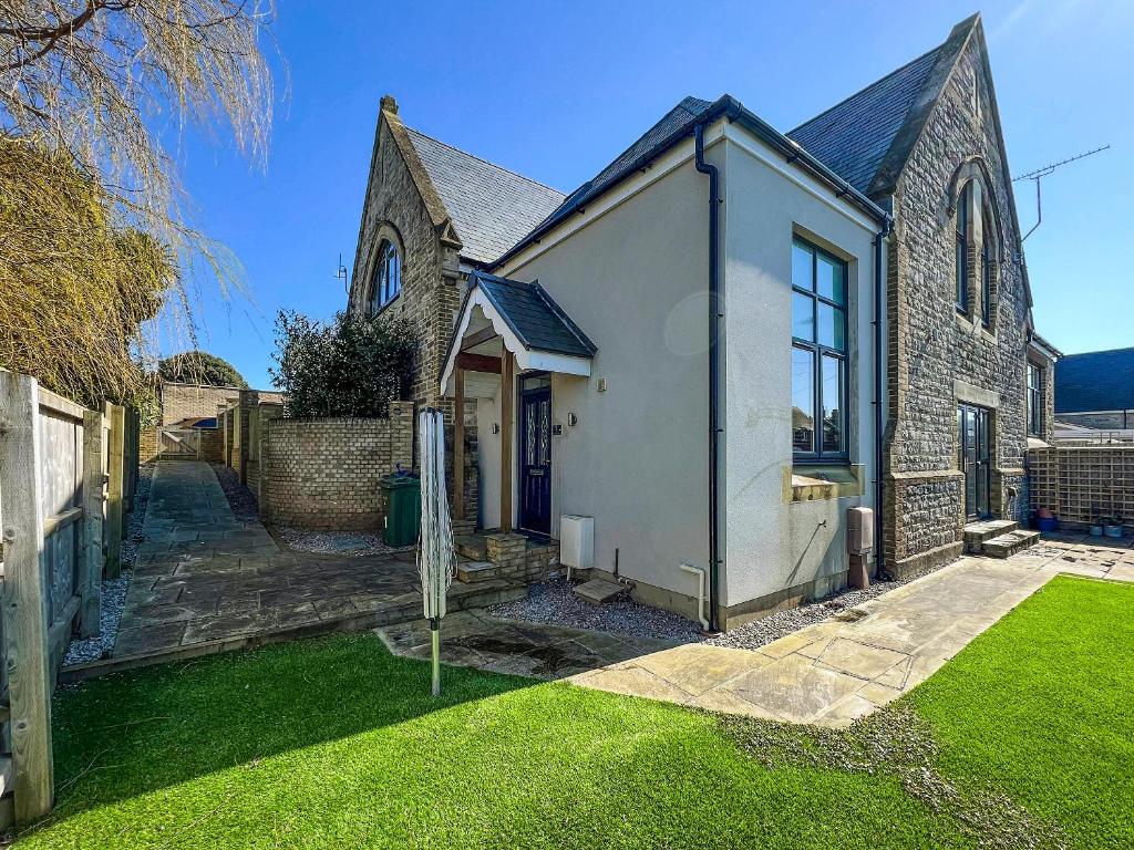 a home with a church and a yard at Old School Mews Too in Shanklin